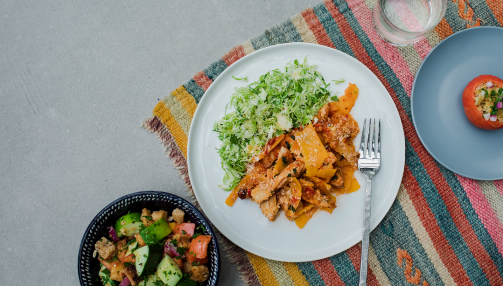 3 plates of food on table cloth photo